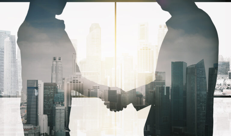 business partners silhouettes making handshake